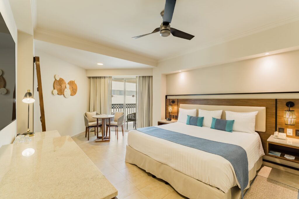 Double bed in a deluxe room with cozy linens and contemporary decor, providing a comfortable stay for guests.