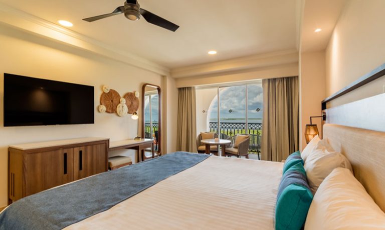 Deluxe Lagoon View Room: Elegant king-size bed setup, providing utmost comfort against the backdrop of stunning lagoon scenery