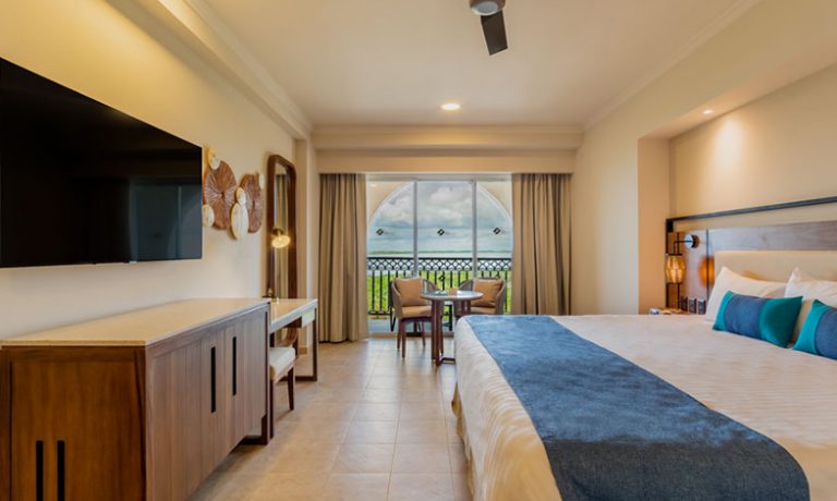 Deluxe Lagoon View Room: Luxurious king-size bed with premium linens, complemented by serene lagoon views.