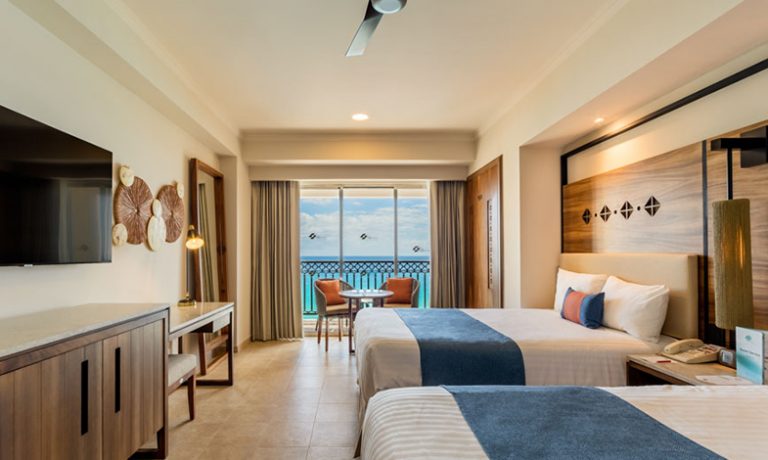 Comfortable double beds complemented by panoramic ocean vistas