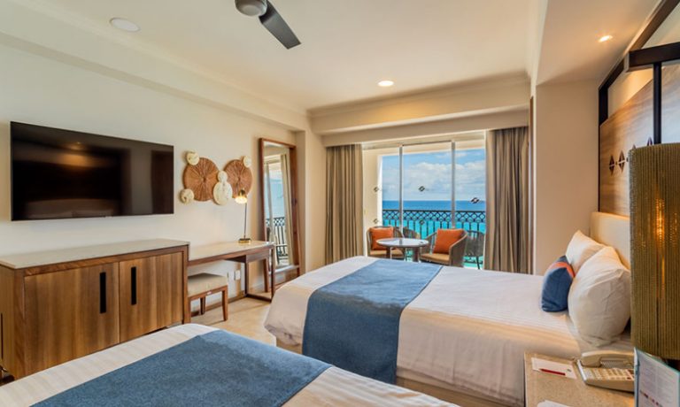 Two cozy beds with luxurious linens, offering unparalleled oceanfront relaxation