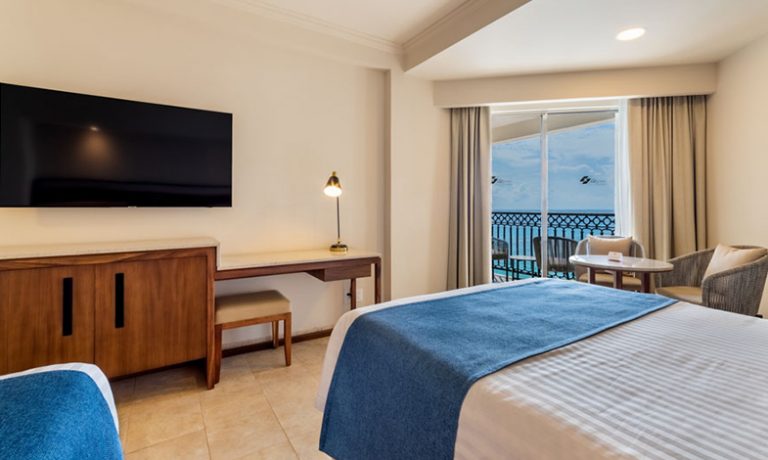 Comfortable individual beds with crisp linens and ocean vistas, perfect for a relaxing stay.