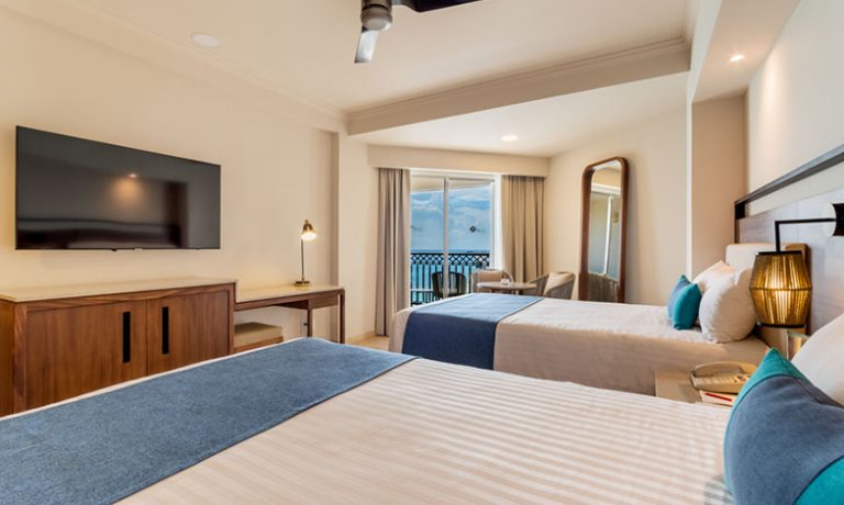 Two cozy single beds complemented by stunning ocean views, offering a tranquil retreat for guests.